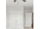 A bedroom closet featuring double doors with round knobs, plus a ceiling fan at 417 Prine Pl # Brx0013, Charlotte, NC 28213