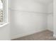 A simple walk-in closet with white walls, carpet and wire shelving at 417 Prine Pl # Brx0013, Charlotte, NC 28213