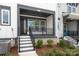 Charming front porch with black railings, white stairs, and gray siding at 417 Prine Pl # Brx0013, Charlotte, NC 28213