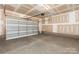 Unfinished two car garage with a metal garage door at 417 Prine Pl # Brx0013, Charlotte, NC 28213