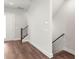 Hallway with wood floors, base trim, staircase, and entry door on the left at 417 Prine Pl # Brx0013, Charlotte, NC 28213