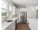 Well-lit kitchen with quartz countertops, stainless steel appliances, and a breakfast bar at 417 Prine Pl # Brx0013, Charlotte, NC 28213