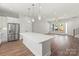 Open kitchen features stainless steel appliances, a large island, and flows into the living area at 417 Prine Pl # Brx0013, Charlotte, NC 28213