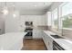 Bright kitchen features white cabinets, stainless steel appliances, pendant lighting, and a large island at 417 Prine Pl # Brx0013, Charlotte, NC 28213