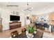 Open concept living room with a flat screen tv, modern decor, and a view into the kitchen at 417 Prine Pl # Brx0013, Charlotte, NC 28213