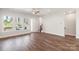Open-concept living area features hardwood floors, large windows, and a staircase at 417 Prine Pl # Brx0013, Charlotte, NC 28213