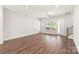 Spacious living room with hardwood floors, large windows, and a ceiling fan at 417 Prine Pl # Brx0013, Charlotte, NC 28213