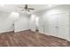 An open living room with wood floors, ceiling fan, storage closet, and ensuite bathroom at 417 Prine Pl # Brx0013, Charlotte, NC 28213