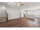 Open-concept living room and kitchen with hardwood floors and staircase at 417 Prine Pl # Brx0013, Charlotte, NC 28213