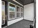 Inviting porch with dark wood flooring and views of the surrounding greenery at 417 Prine Pl # Brx0013, Charlotte, NC 28213