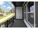 Inviting covered porch with black railings and a view of the neighborhood at 417 Prine Pl # Brx0013, Charlotte, NC 28213