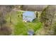 An aerial shot showcases a home with a metal roof, a patio, and a large surrounding yard at 166 Rosalind Ln, Statesville, NC 28677