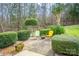 Well-manicured backyard with sculpted bushes and comfortable seating for outdoor relaxation at 166 Rosalind Ln, Statesville, NC 28677