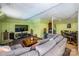 Finished basement features a sitting area with furniture, a dining set, and a large screen TV at 166 Rosalind Ln, Statesville, NC 28677