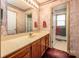 Cozy bathroom features a marble-patterned wall, a built-in vanity, and a large framed mirror at 166 Rosalind Ln, Statesville, NC 28677
