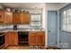 Kitchen featuring wood cabinets, a stainless steel sink, and a blue-painted door to backyard at 166 Rosalind Ln, Statesville, NC 28677