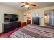 Bedroom featuring a large dresser, striped bedding, ceiling fan, and a bathroom in the background at 166 Rosalind Ln, Statesville, NC 28677