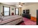 Cozy bedroom with a striped comforter, dark wood furniture, and natural light from the windows at 166 Rosalind Ln, Statesville, NC 28677
