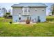 Back patio featuring a dining set, chairs, and woodpile, with access to the home at 166 Rosalind Ln, Statesville, NC 28677