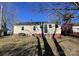 Ranch home with yard, steps to the front door, and mature trees at 431 E 12Th Ave, Gastonia, NC 28054