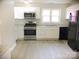 Renovated kitchen featuring white cabinets and modern appliances at 431 E 12Th Ave, Gastonia, NC 28054