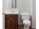 Bathroom features a vintage vanity with a ceramic sink and toilet at 1302 Hickory Nut Ln, Lincolnton, NC 28092