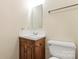 Bathroom with wood cabinet vanity, ceramic sink, and a toilet at 1302 Hickory Nut Ln, Lincolnton, NC 28092