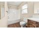 This bathroom features a wood grain floor, shower and tub with a sliding door and vanity with sink at 1302 Hickory Nut Ln, Lincolnton, NC 28092