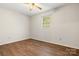 A bedroom with vinyl floors and a window that provides natural light at 1302 Hickory Nut Ln, Lincolnton, NC 28092