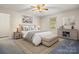 This primary bedroom features neutral paint and decor, a ceiling fan, and lots of natural light at 1302 Hickory Nut Ln, Lincolnton, NC 28092