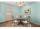 Charming dining area with round table and seating for four with natural lighting at 1302 Hickory Nut Ln, Lincolnton, NC 28092