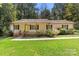 Inviting single story home with a cozy front porch and well-maintained landscaping at 1302 Hickory Nut Ln, Lincolnton, NC 28092
