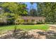 Charming home featuring a well-manicured front yard and mature trees creating a peaceful setting at 1302 Hickory Nut Ln, Lincolnton, NC 28092
