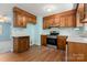 Kitchen with wooden cabinets, stainless steel appliances, and vinyl flooring at 1302 Hickory Nut Ln, Lincolnton, NC 28092