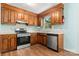 Functional kitchen with stainless steel appliances and warm wood cabinets for a welcoming cooking experience at 1302 Hickory Nut Ln, Lincolnton, NC 28092