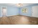 Spacious living room with hardwood floors and ample natural light; an inviting space for relaxation at 1302 Hickory Nut Ln, Lincolnton, NC 28092
