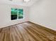 Neutral bedroom with hardwood floors and large window with backyard view at 7210 Morningdew Ct, Denver, NC 28037