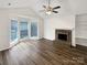 Bright living room with a cozy fireplace, built-in shelves, and large windows for natural light at 7210 Morningdew Ct, Denver, NC 28037