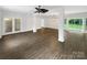 Large open living room featuring high ceilings, hardwood floors, and lots of light at 7210 Morningdew Ct, Denver, NC 28037