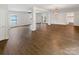 Open living room with stylish lighting, hardwood floors, and natural light at 7210 Morningdew Ct, Denver, NC 28037