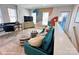 Bright bonus room features a comfy couch, a workspace, and stylish wall art at 1013 North End Dr # 26, Charlotte, NC 28206