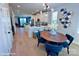 Bright dining area with a wooden table and blue chairs, adjacent to kitchen at 1013 North End Dr # 26, Charlotte, NC 28206