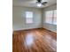 Spacious bedroom with hardwood floors and ample natural light from two windows at 3918 Barlowe Rd, Charlotte, NC 28208