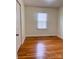 Simple bedroom with hardwood floors and a window for natural light at 3918 Barlowe Rd, Charlotte, NC 28208