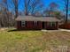 Brick ranch home with a landscaped yard and driveway at 3918 Barlowe Rd, Charlotte, NC 28208