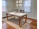 Modern home office with hardwood floors and a large workspace at 3918 Barlowe Rd, Charlotte, NC 28208