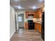 Bright kitchen with wood cabinets, granite counters, and black appliances at 3918 Barlowe Rd, Charlotte, NC 28208