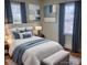 Main bedroom with plush bedding, stylish decor and hardwood floors at 3918 Barlowe Rd, Charlotte, NC 28208