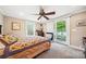 Cozy bedroom with access to a private balcony overlooking the lake, with a ceiling fan at 501 Nivens Cove Rd, Mount Holly, NC 28120
