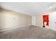 Carpeted bedroom with neutral walls and ceilings and a bathroom en suite at 501 Nivens Cove Rd, Mount Holly, NC 28120